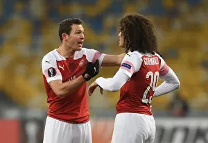 FC Vorskla Poltava V Arsenal 2018-19 Prints: Arsenal's Guendouzi and Lichtsteiner in Action against Vorskla Poltava in Europa League
