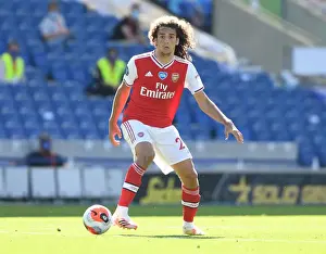 Brighton And Hove Albion V Arsenal 2019-20 Prints: Arsenal's Guendouzi Plays On: Empty Premier League Match Amidst Coronavirus Pandemic