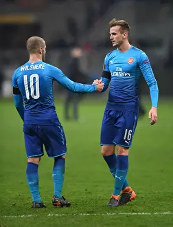 AC Milan V Arsenal 2017-18 Prints: Arsenal's Holding and Wilshere Share a Moment after AC Milan Clash in Europa League