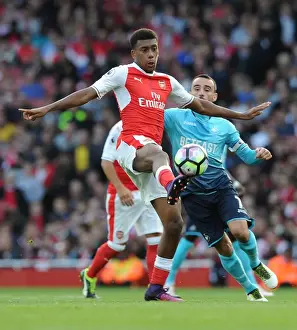 Arsenal V Swansea City 2016-17 Prints: Arsenal's Iwobi Goes Head-to-Head with Swansea's Britton in Premier League Showdown