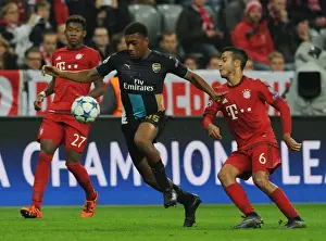 Bayern Munich V Arsenal 2015-16 Prints: Arsenal's Iwobi Overpowers Thiago in Champions League Clash