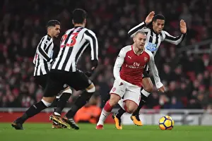 Arsenal's Jack Wilshere Clashes with Newcastle's Midfield Trio during Premier League Match