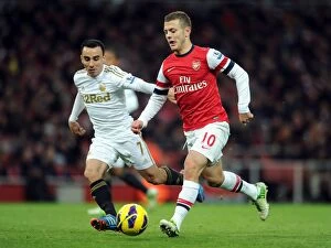 Arsenal v Swansea 2012-13 Collection: Arsenal's Jack Wilshere Clashes with Swansea's Leon Britton during the 2012-13 Premier League Match