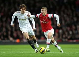 Arsenal v Swansea 2012-13 Collection: Arsenal's Jack Wilshere Clashes with Swansea's Miguel Michu in Premier League Showdown (2012-13)