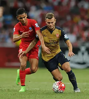 Arsenal V Singapore XI Prints: Arsenal's Jack Wilshere Fends Off Singapore XI's Safuwan Baharudin During Barclays Asia Trophy Match