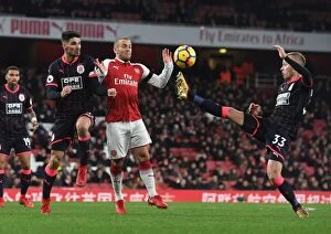 Arsenal v Huddersfield Town 2017-18 Collection: Arsenal's Jack Wilshere Goes Head-to-Head with Schindler and Hadergjonaj in Intense Premier League