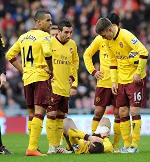 Images Dated 9th February 2013: Arsenal's Jack Wilshere Injured: Theo Walcott, Santi Cazorla, and Aaron Ramsey React