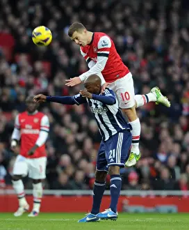 Arsenal V West Bromwich Albion 2012-13 Prints: Arsenal's Jack Wilshere Leaps Over Youssouf Mulumbu (2012-13)