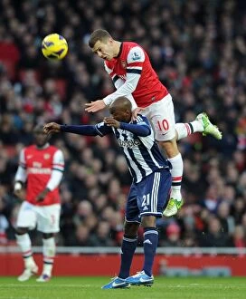 Images Dated 8th December 2012: Arsenal's Jack Wilshere Leaps Over Youssouf Mulumbu (2012-13)