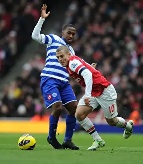 Arsenal's Jack Wilshere Outmaneuvers QPR's Junior Hoilett during the 2012-13 Premier League Match