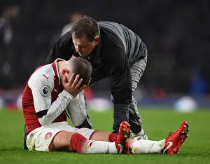 Arsenal V Crystal Palace 2017-18 Prints: Arsenal's Jack Wilshere Receives Medical Attention from Physio Colin Lewin during Premier League Match