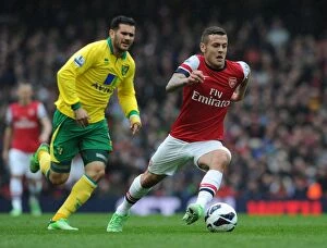 Images Dated 13th April 2013: Arsenal's Jack Wilshere Surges Past Norwich's Bradley Johnson in 2012-13 Premier League Clash