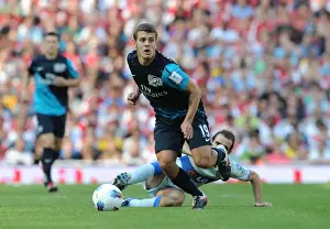 Arsenal's Jack Wilshere vs. Leandro Somoza: A Clash of Midfield Titans at the Emirates Cup, 2011
