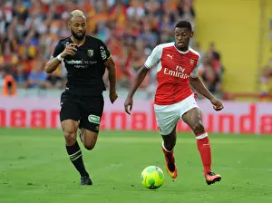 Lens V Arsenal 2016-17 Prints: Arsenal's Jeff Reine-Adelaide vs John Bostock: Intense Face-Off in Lens Friendly, 2016