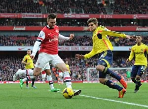 Images Dated 22nd February 2014: Arsenal's Jenkinson Faces Off Against Alonso in Intense Premier League Clash