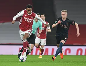 Arsenal's Joe Willock Battles Past Manchester City's Oleksandr Zinchenko in Carabao Cup Quarterfinal