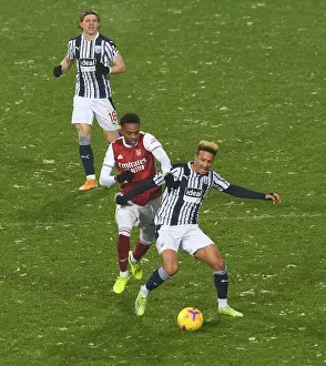 Arsenal's Joe Willock Clashes with West Bromwich Albion's Callum Robinson in Premier League Showdown