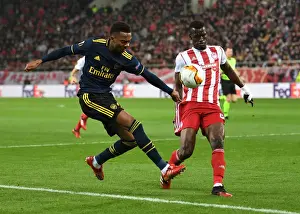 Olympiacos V Arsenal 2019-20 Prints: Arsenal's Joe Willock Faces Off Against Olympiacos Ousseynou Ba in Europa League Clash