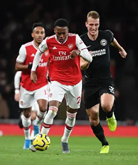 Arsenal's Joe Willock Outmaneuvers Brighton's Dan Burn in Premier League Clash