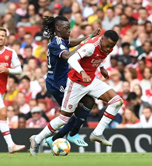 Arsenal's Joe Willock Outmaneuvers Lyon's Bertrand Traore at Emirates Cup