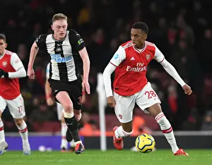 Arsenal's Joe Willock Outmaneuvers Newcastle's Sean Longstaff in Premier League Clash