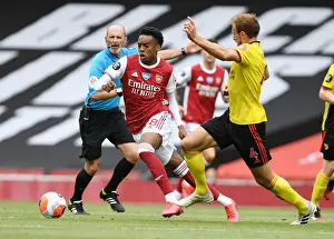 Arsenal's Joe Willock Outmaneuvers Watford's Craig Dawson in Premier League Clash