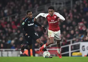 Arsenal V West Ham United - Carabao Cup 2017-18 Prints: Arsenal's Joe Willock vs. Diafra Sakho: Intense Showdown in Carabao Cup Clash