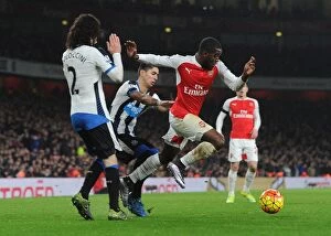 Arsenal v Newcastle United 2015-16 Collection: Arsenal's Joel Campbell Faces Off Against Newcastle's Coloccini