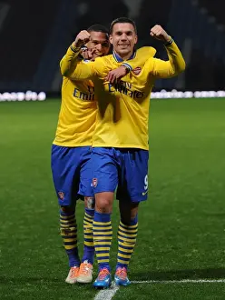 West Ham United V Arsenal 2013-14 Prints: Arsenal's Jubilant Winning Moment: Podolski and Gibbs Celebrate against West Ham United