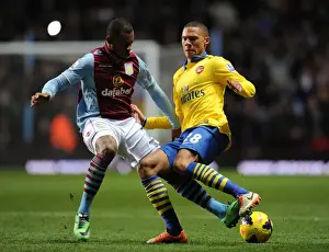 Aston Villa V Arsenal 2013-14 Prints: Arsenal's Kieran Gibbs Fends Off Aston Villa's Leandro Bacuna During Premier League Clash