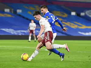 Brighton And Hove Albion V Arsenal 2020-21 Prints: Arsenal's Kieran Tierney Faces Off Against Brighton's Joel Veltman in Empty American Express Community Stadium