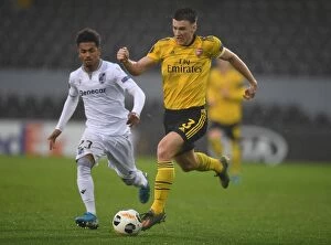 Vitoria SC v Arsenal 2019-20 Collection: Arsenal's Kieran Tierney Goes Head-to-Head with Marcus Edwards in Europa League Showdown