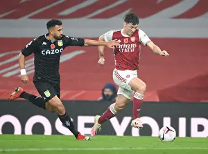Arsenal's Kieran Tierney Outmaneuvers Aston Villa's Trezeguet in Empty Emirates Stadium