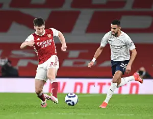 Arsenal's Kieran Tierney Outmaneuvers Manchester City's Riyad Mahrez in Empty Emirates Stadium