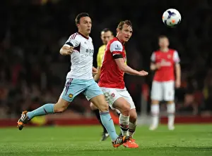 Arsenal's Kim Kallstrom Faces Mark Noble Pressure in Premier League Clash (2013/14)