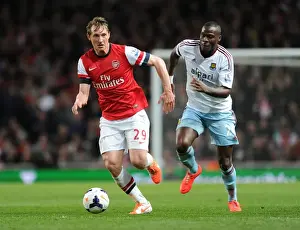 Arsenal V West Ham United 2013/14 Prints: Arsenal's Kim Kallstrom Outwits Guy Demel: A Thrilling Moment from the Arsenal vs