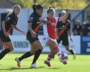 Arsenal's Kim Little Fights Past Defender in FA WSL Clash