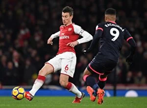Arsenal v Huddersfield Town 2017-18 Collection: Arsenal's Koscielny Clashes with Huddersfield's Kachunga in Premier League Showdown
