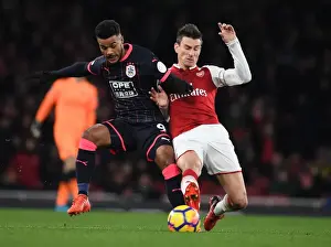 Arsenal V Huddersfield Town 2017-18 Prints: Arsenal's Koscielny Faces Off Against Huddersfield's Kachunga in Premier League Clash