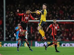 AFC Bournemouth V Arsenal 2016-17 Prints: Arsenal's Koscielny Heads Away from Stanislas in AFC Bournemouth Clash (2016-17)