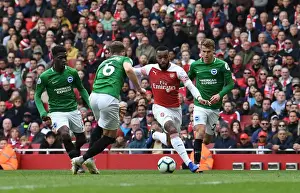Arsenal's Lacazette Clashes with Brighton's Defenders during Premier League Showdown