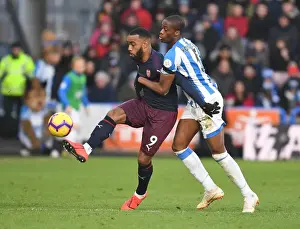Arsenal's Lacazette Clashes with Huddersfield's Kongolo in Intense Premier League Battle