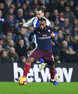 Brighton And Hove Albion V Arsenal 2018-19 Prints: Arsenal's Lacazette Clashes with Propper in Brighton-Arsenal Premier League Showdown