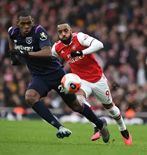 Arsenal V West Ham United 2019-20 Prints: Arsenal's Lacazette Clashes with West Ham's Diop in Premier League Showdown