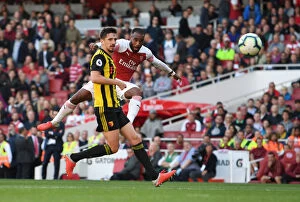 Arsenal v Watford 2018-19 Collection: Arsenal's Lacazette Faces Off Against Cathcart in Intense Premier League Clash