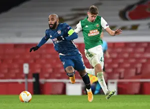 Arsenal V SK Rapid Wien 2020-21 Prints: Arsenal's Lacazette Faces Off Against Rapid Wien's Schuster in Europa League Clash