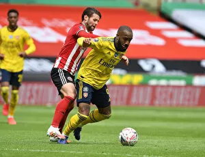 Images Dated 28th June 2020: Arsenal's Lacazette Faces Off Against Sheffield United's Egan in FA Cup Quarterfinal Clash