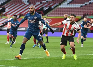 Arsenal's Lacazette Faces Off Against Sheffield United's Baldock in Empty Bramall Lane