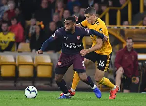 Wolverhampton Wanderers V Arsenal 2018-19 Prints: Arsenal's Lacazette Faces Off Against Wolverhampton's Coady in Premier League Clash