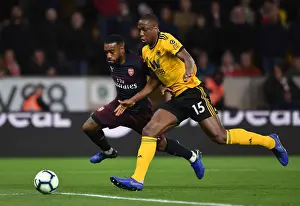 Wolverhampton Wanderers V Arsenal 2018-19 Prints: Arsenal's Lacazette Faces Off Against Wolves Boly in Premier League Clash (2018-19)